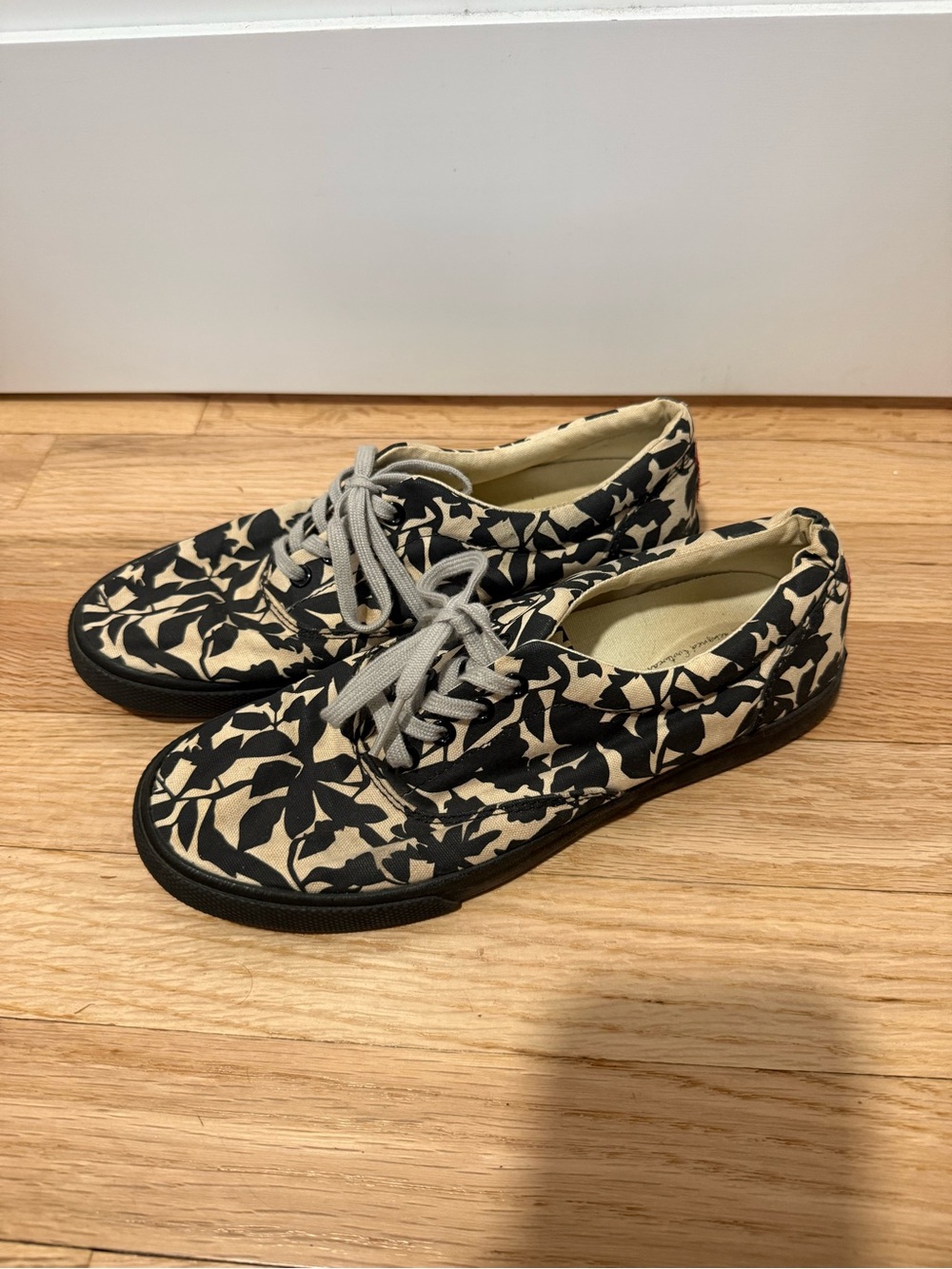 Bucket Feet Black Floral Canvas Sneakers with Cream Background